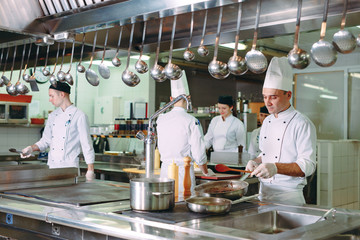 Modern kitchen. The chefs prepare meals in the restaurant's kitchen.