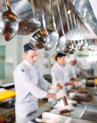 Modern kitchen. The chefs prepare meals in the restaurant's kitchen.