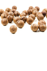 Fototapeta premium Raw not peeled whole macadamia nuts isolated on white