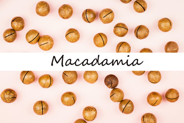 Fototapeta premium Raw not peeled macadamia nuts on pink background.