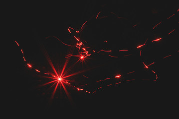 Red laser ray on black background.