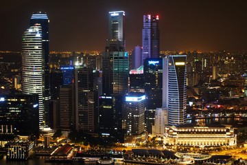 Fototapeta na wymiar Marina Bay skyline with skyscrapers illuminated at night, Singapore 