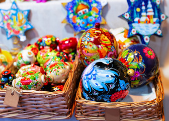 Wooden souvenirs at Christmas Market at Gendarmenmarkt in Winter Berlin, Germany. Advent Fair Decoration and Stalls with Crafts Items on Bazaar.