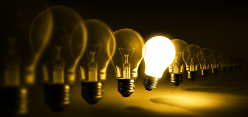 Glowing light bulb on orange background, idea concept