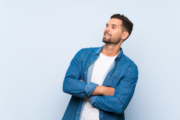 Handsome man over isolated blue background happy and smiling