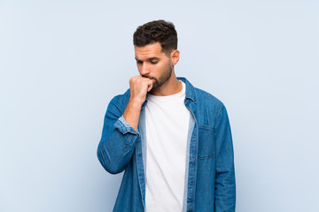 Handsome man over isolated blue background having doubts