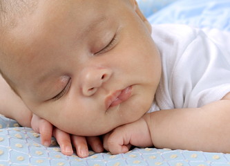baby sleeping wrapped up in blanket just been cared for after having a good sleep in bed stock photograph stock photo