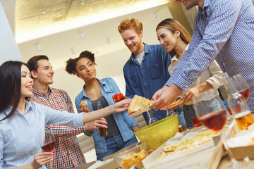 Group of friends having party indoors fun together celebrating new year casual