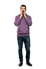 Full-length shot of Handsome man with sweatshirt shouting and announcing something over isolated white background