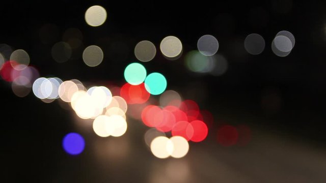 defocused blurry red white yellow car lights ,oving on city streen in the evening after dusk