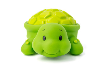 Rubber toy green turtle on a white background. Child's toy green turtle isolated over white...