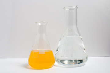 Laboratory glassware filled with chemical liquids on a white background. Science.