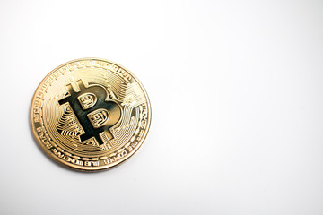 Closeup of a shiny golden Bitcoin coin on a white background. Cryptocurrency BTC.