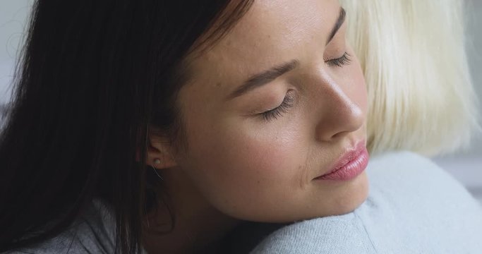 Empathic young daughter embrace console take care of old mother