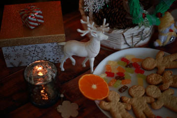 Christmas wreath with gifts and sweets with deer and orange