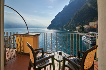 View from the room window of Garda lake surrounded by mountains in the summertime, the port of Riva del Garda and the beautiful Riva del Garda town, , Italy