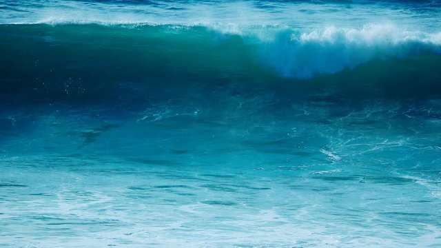 Ocean Wave Slow Motion Water Blue stunning closeup, crashing breaking rolling with white foam, sea nature background 