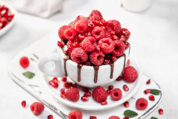 Raspberry mug cake in a white ceramic mug on white background