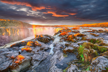 Dramatic sunset view of fantastic waterfall and cascades of Selfoss waterfall.