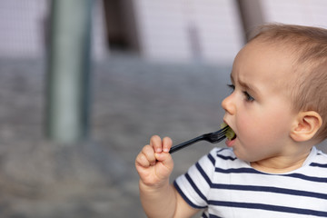 Baby girl eating pre-cut grapes