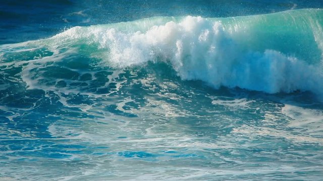 Ocean wave. Sea wave. Big surf wave. Slow motion of big ocean wave slowly crashing, breaking, rolling.