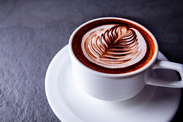 Top view of hot coffee latte art on concrete table