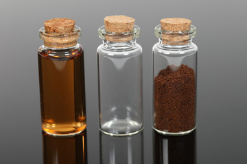 A number of small glass bottles with powders and liquids.