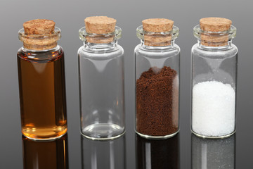 A number of small glass bottles with powders and liquids.