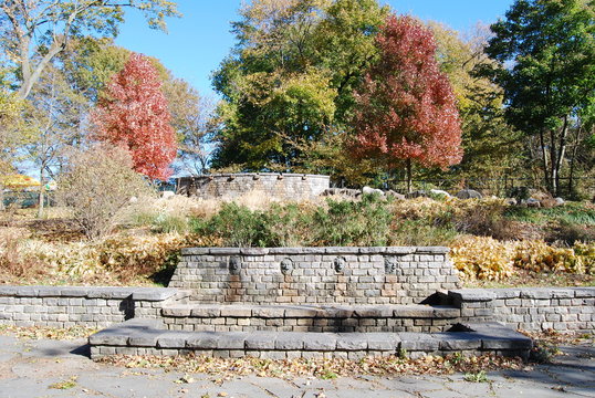 A fall scene with the four season showing on a stone wall