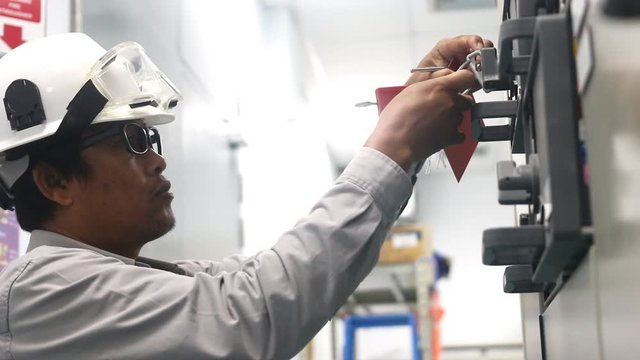 Engineer to check electrical control cabinet in substation building