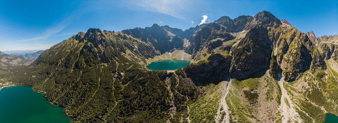 Panorama Aerial view of Black Lake below Mount Rysy. It overlooks the nearby lake of Morskie Oko, or Eye of the Sea in Tatra Mountains. Poland - obrazy, fototapety, plakaty