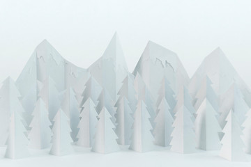White winter paper landscape with mountains and pine trees 