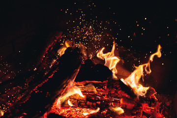 burning fire logs with sparks in the fireplace