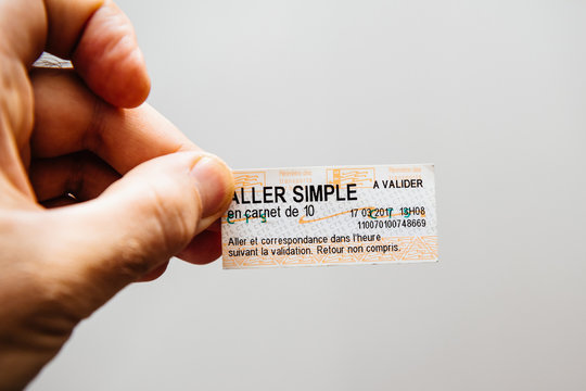 PARIS, FRANCE - FEB 21, 2018: Man holding against white background ticket from CTS Strasbourg Tramway and Bus public transportation network