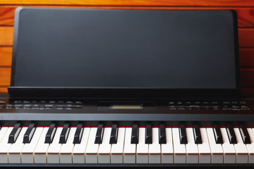 digital piano keys with music stand, copy-space background