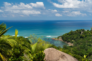 Scenic landscape view from top of fond ferdinand nature reserve in Praslin on a turquoise sea. Amazing views of Seychelles and Indian Ocean. - obrazy, fototapety, plakaty