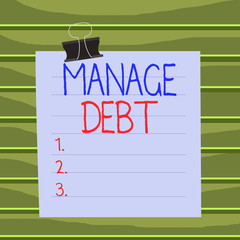 Conceptual hand writing showing Manage Debt. Concept meaning unofficial agreement with unsecured creditors for repayment Paper lines binder clip suare notebook color background