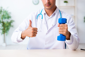 Young male doctor in sport and dieting concept