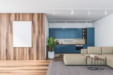 Blue and wooden kitchen with sofa and poster