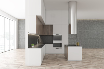 Side view of white and concrete kitchen, island