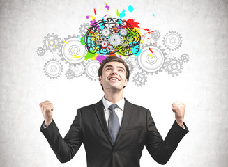 Happy businessman, brain with gears