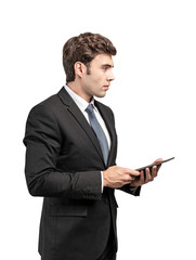 Serious young businessman with tablet, isolated
