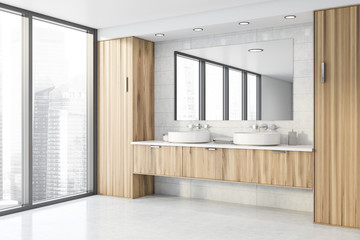 Double sink in white tile bathroom corner