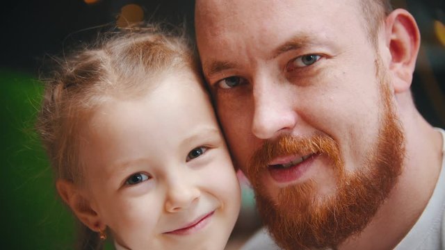 Caucasian family - a dad and daughter - a man with ginger beard