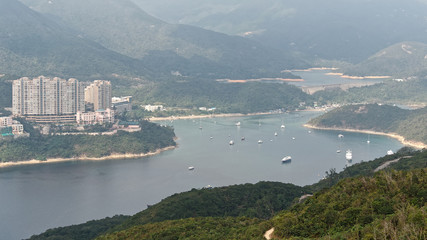 Obraz premium Landscape viewed on the ridge of dragons's back in Hong kong, this is a famous hiking route to enjoy rural life in modern city.