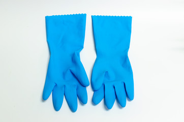 Blue rubber gloves with cleaning on a white background