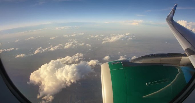 View out of airplane window as the wing takes a dramatic dip with the plane turning right