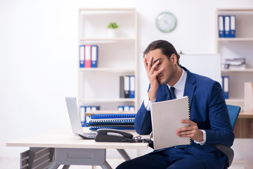 Young male businessman working in the office