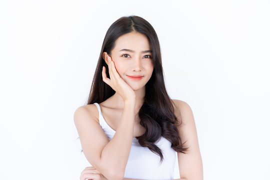 Young asian woman has smiling face and bright skin tone.Asian woman standing with isolated white background.