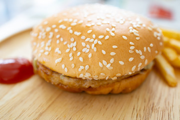 Fresh hamburger on a wooden plate